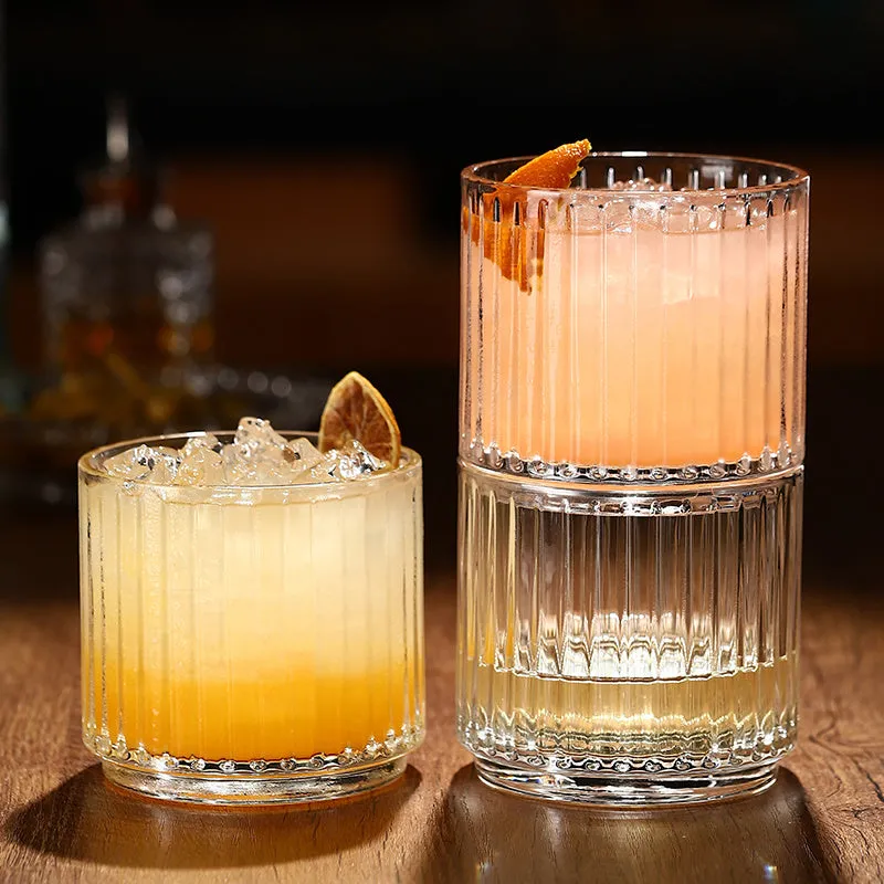 Stackable engraved glass wine glasses and sake barrel on a table