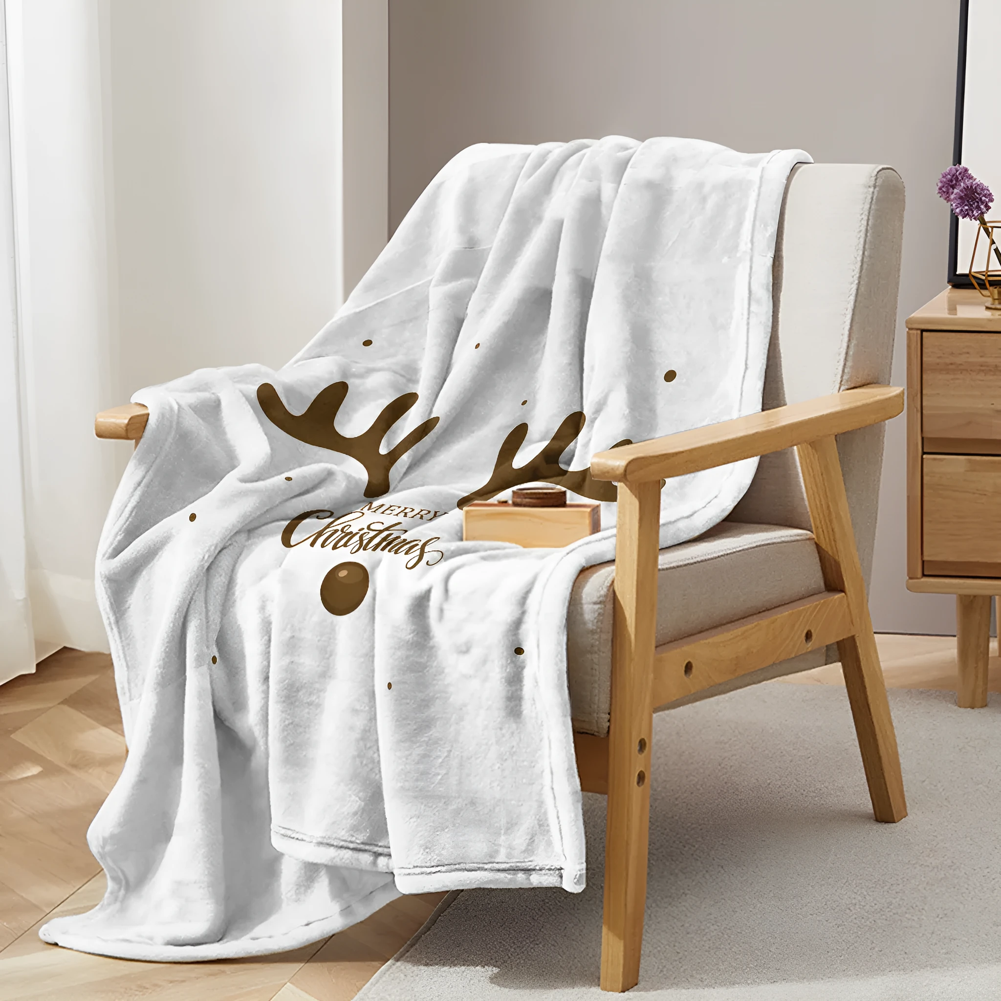 White flannel velvet deer antler pattern Christmas blanket on a sofa