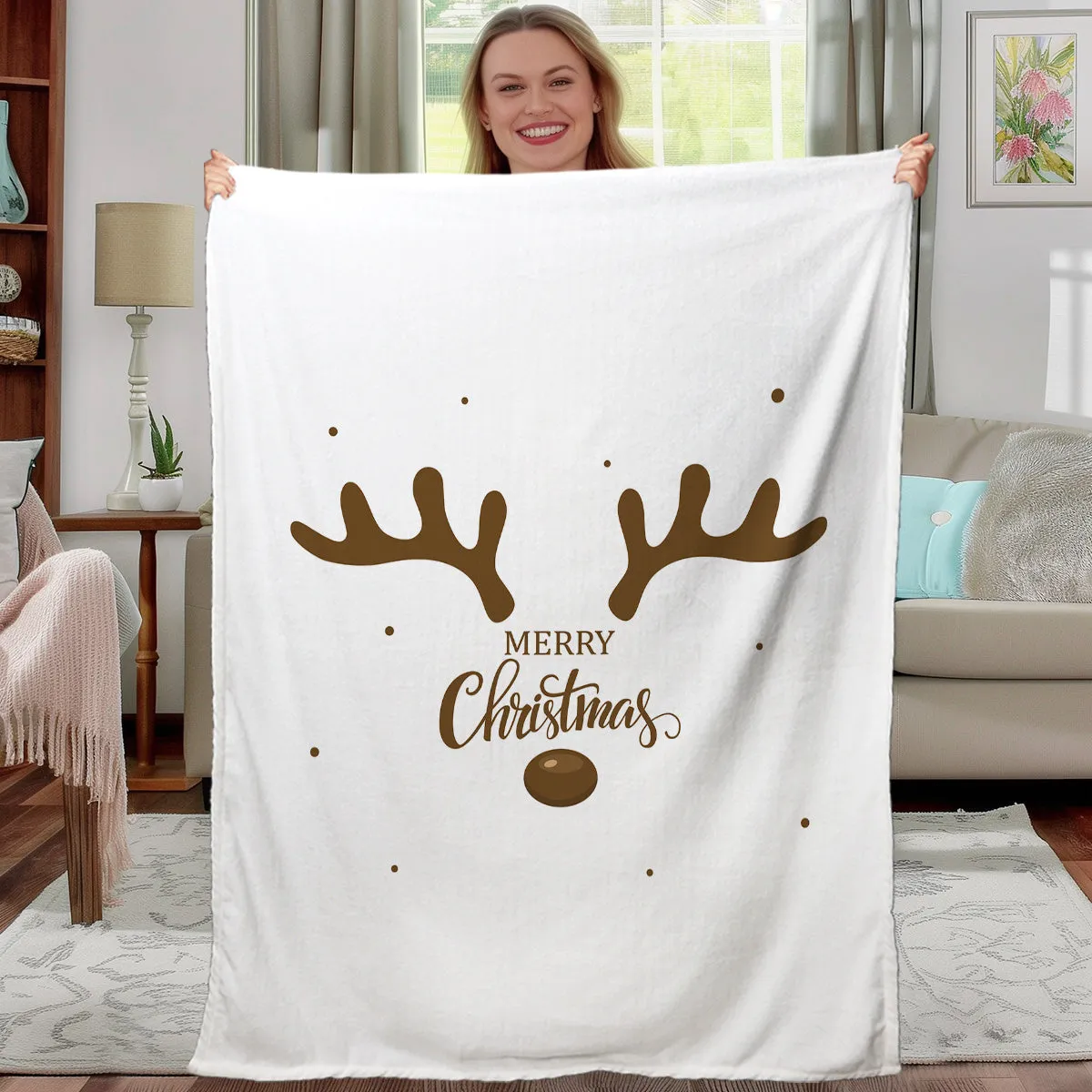 White flannel velvet deer antler pattern Christmas blanket on a sofa