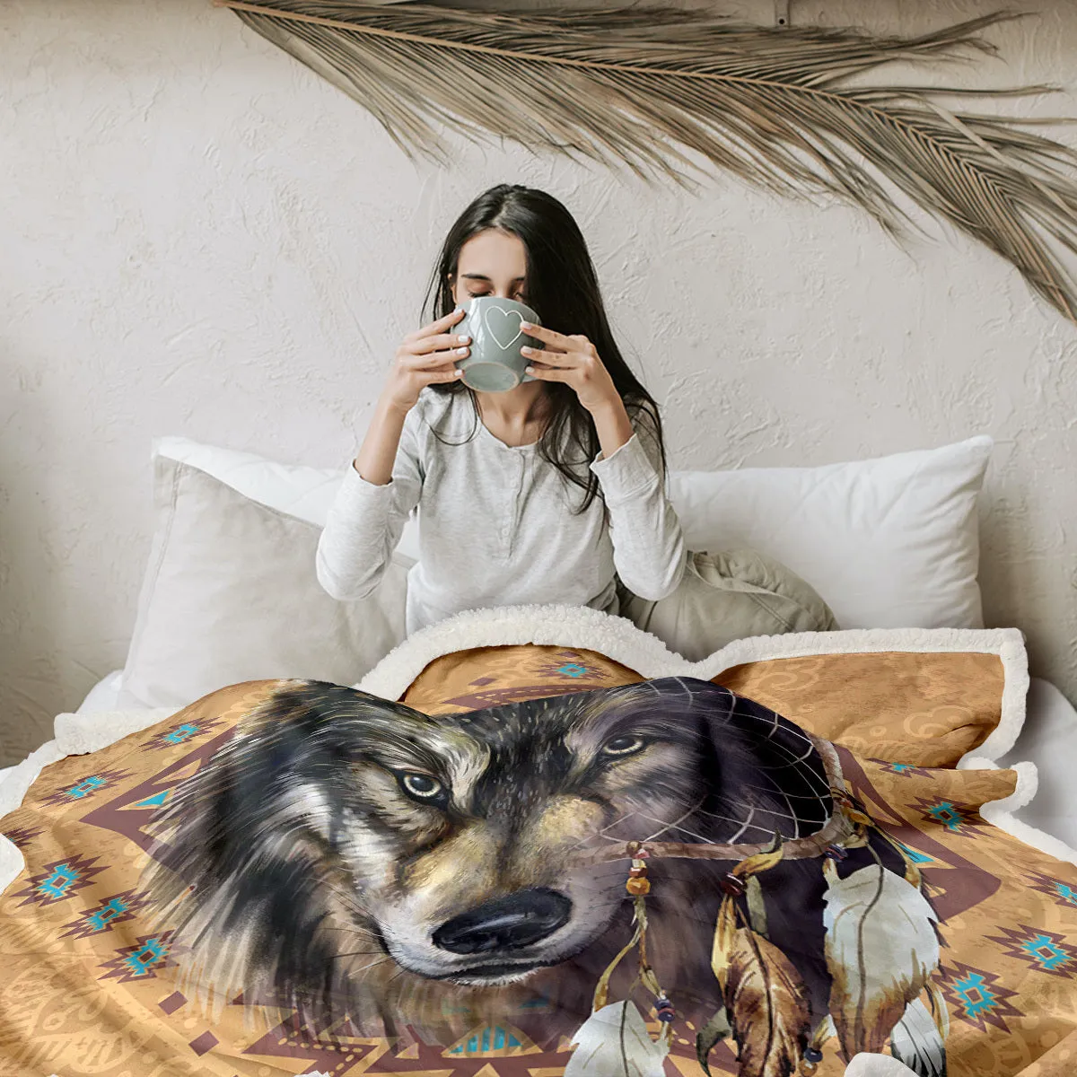 Brown Sherpa fleece throw blanket with wolf head pattern on a couch