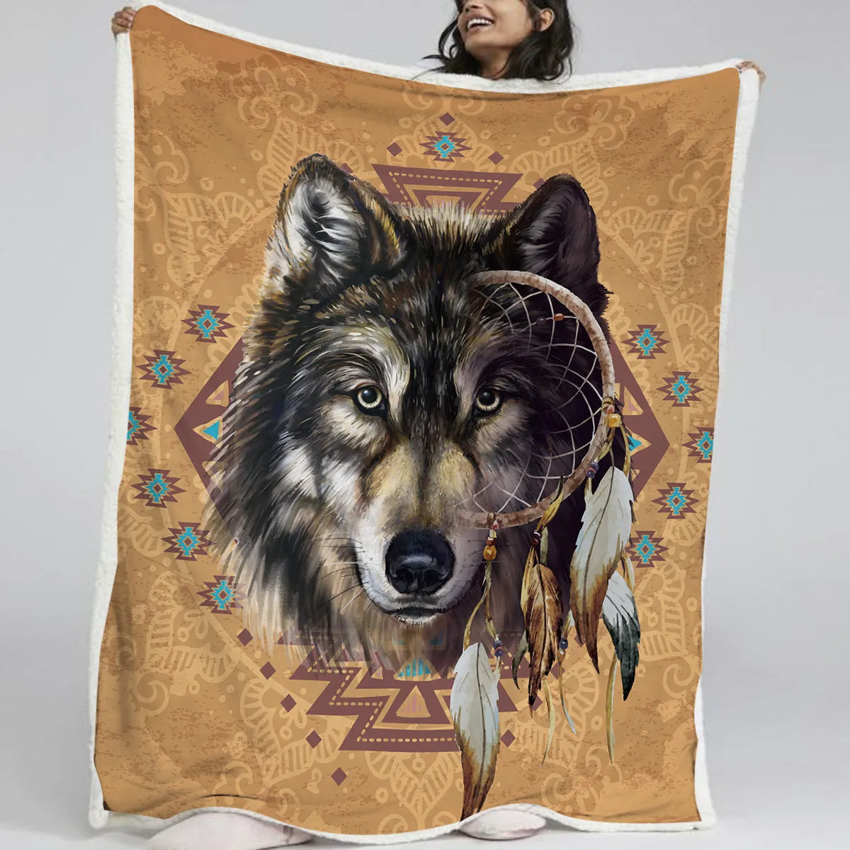 Brown Sherpa fleece throw blanket with wolf head pattern on a couch