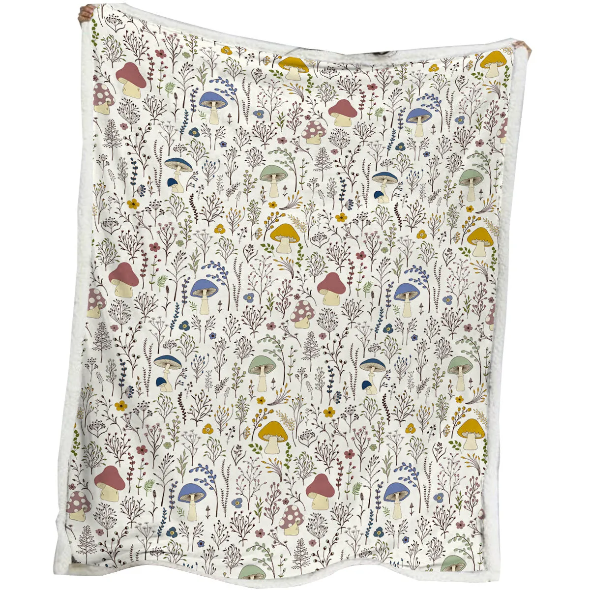 White Sherpa fleece blanket with tree leaf mushroom pattern, sized 130x150cm, on a sofa