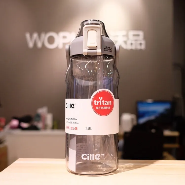Grey plastic water bottle with black cap and clear straw showing scale markings on the side