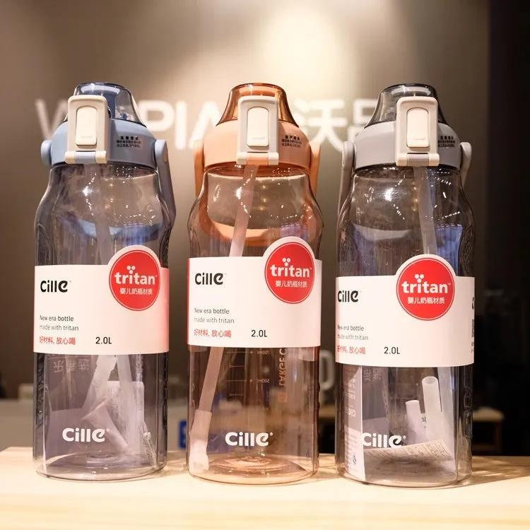 Grey plastic water bottle with black cap and clear straw showing scale markings on the side