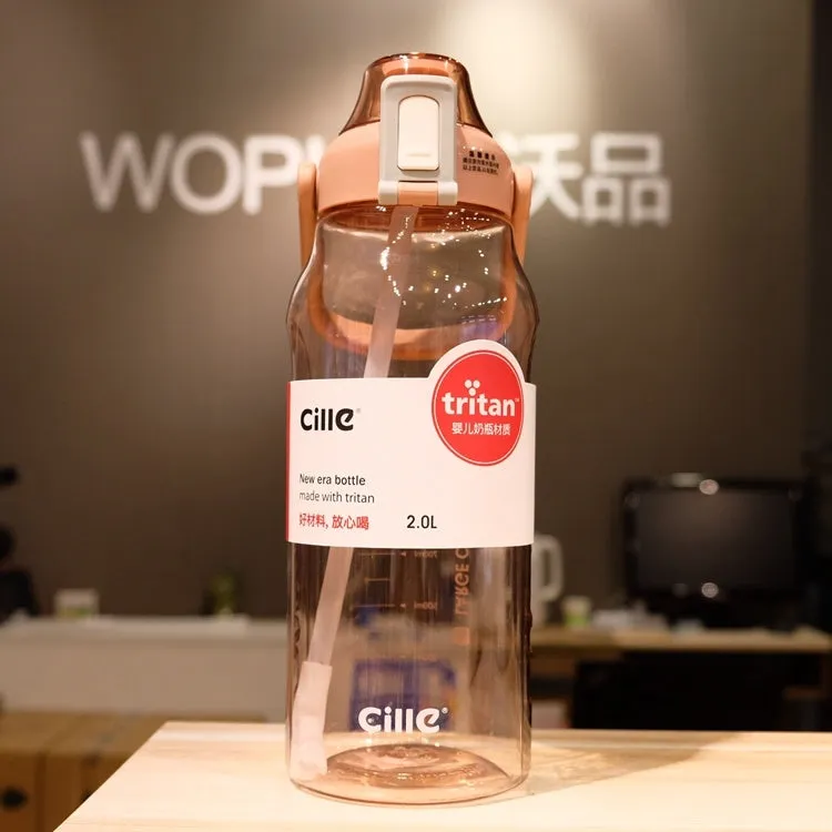 Grey plastic water bottle with black cap and clear straw showing scale markings on the side