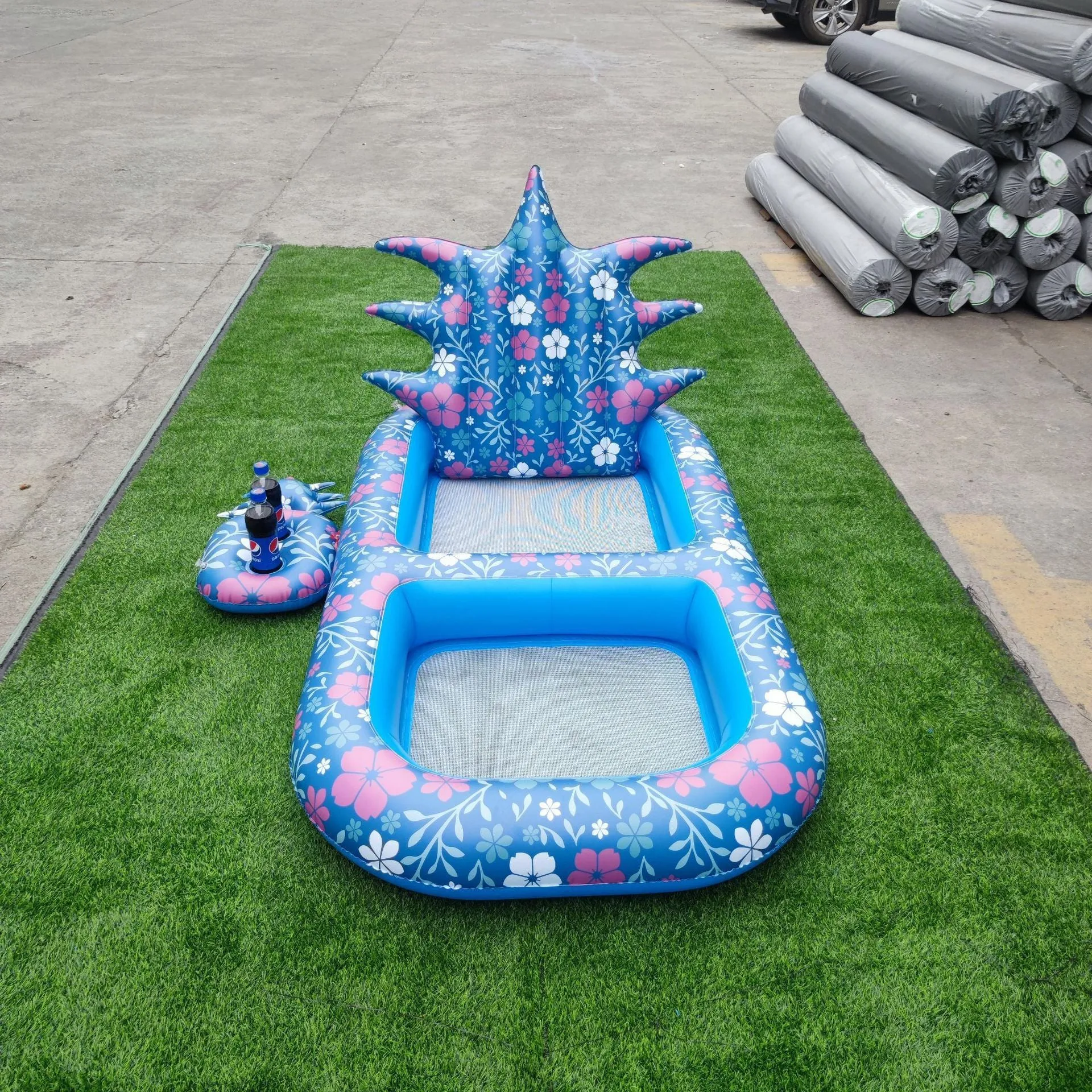 Inflatable pineapple pool lounger with cup holder floating on water in yellow colour
