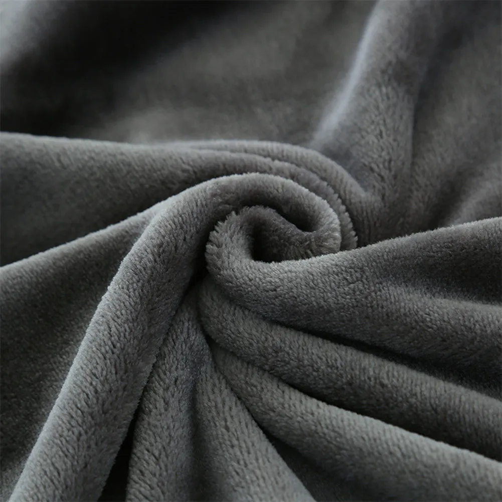 Grey tweed electric heating blanket on a bed, showing simple solid colour design