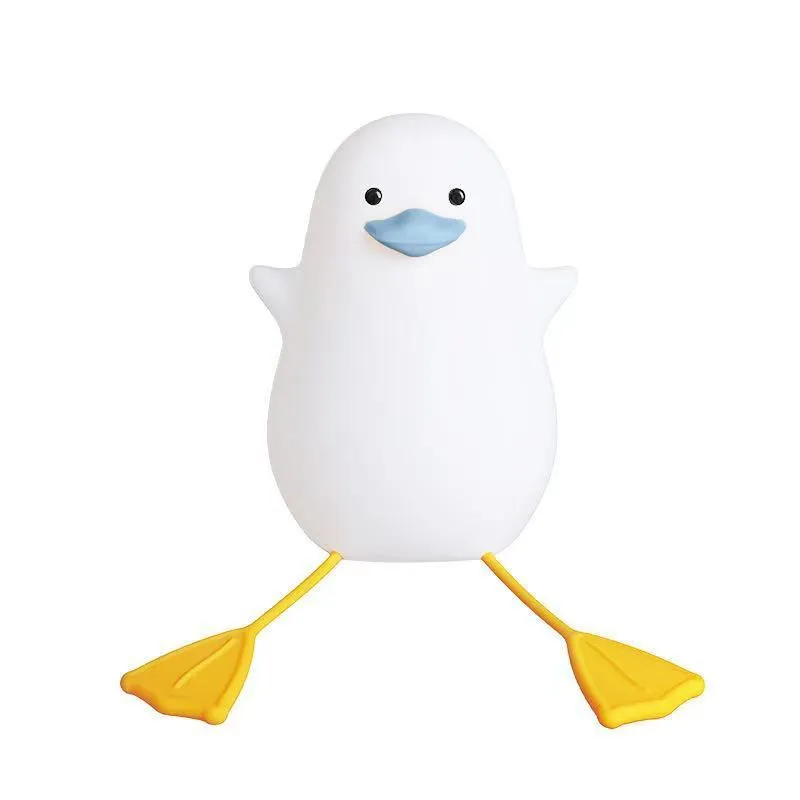 Seagull silicone night light in yellow colour with soft warm glow on bedside table