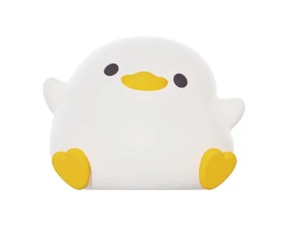 Seagull silicone night light in yellow colour with soft warm glow on bedside table