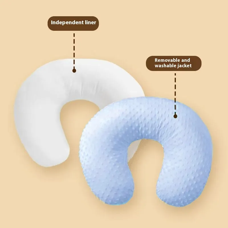 Grey nursing pillow for breastfeeding with removable cover on a neutral background