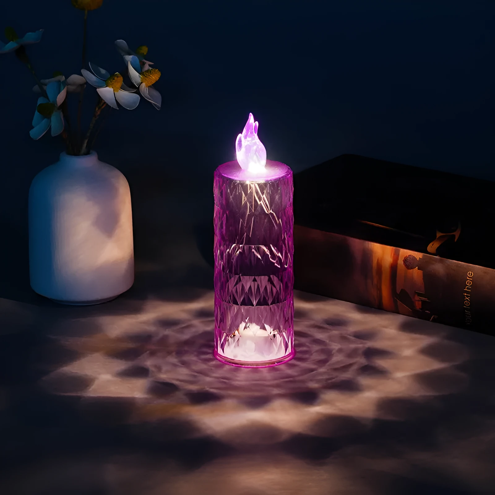 LED electronic candle lamp in ABS plastic with diamond style pattern, transparent colour, shown with base