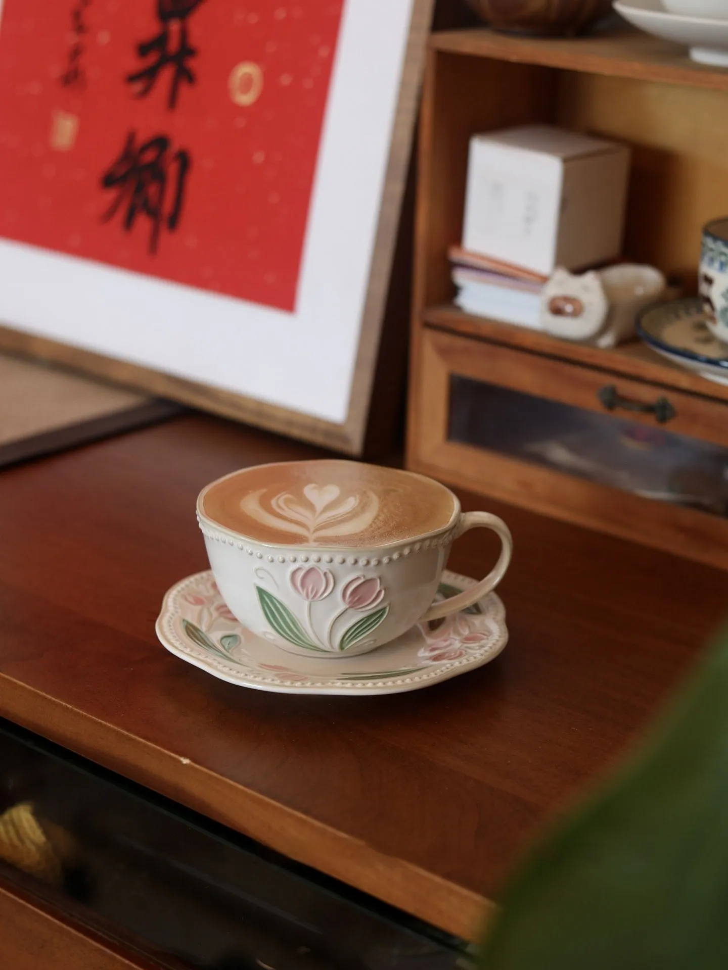Ceramic tulip carved flower retro steam pitcher with curved handle and saucer on a table