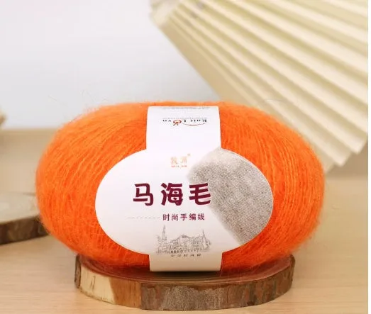 DIY mohair scarf knitting kit showing a ball of wool with 34 colour options including white, grey, pink, and blue.