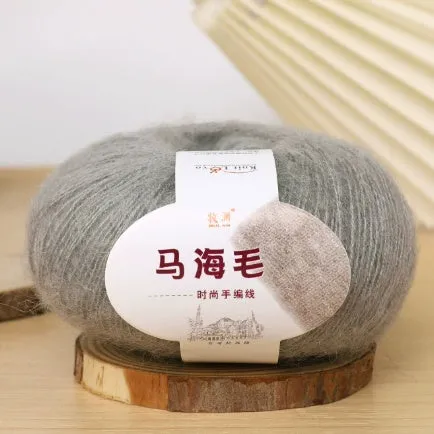 DIY mohair scarf knitting kit showing a ball of wool with 34 colour options including white, grey, pink, and blue.