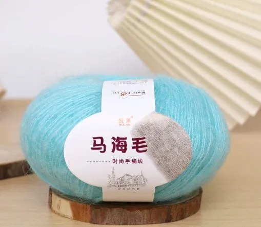 DIY mohair scarf knitting kit showing a ball of wool with 34 colour options including white, grey, pink, and blue.