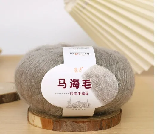 DIY mohair scarf knitting kit showing a ball of wool with 34 colour options including white, grey, pink, and blue.