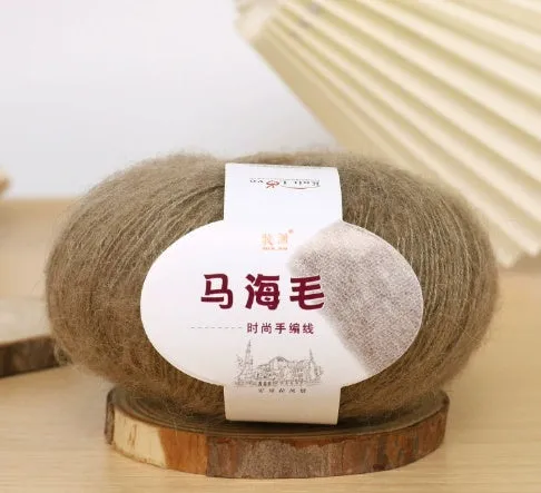 DIY mohair scarf knitting kit showing a ball of wool with 34 colour options including white, grey, pink, and blue.