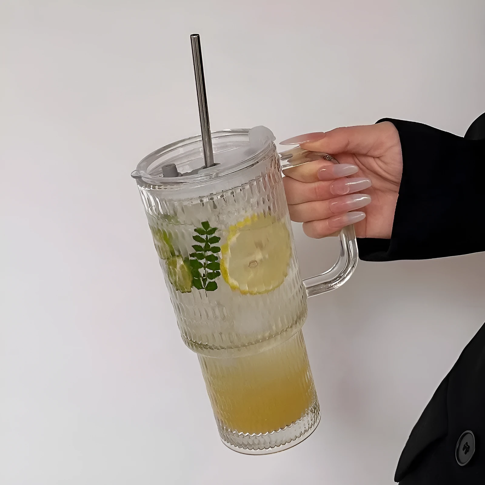 740ml hand-blown glass cup with handle, lid, and curved straw on a table