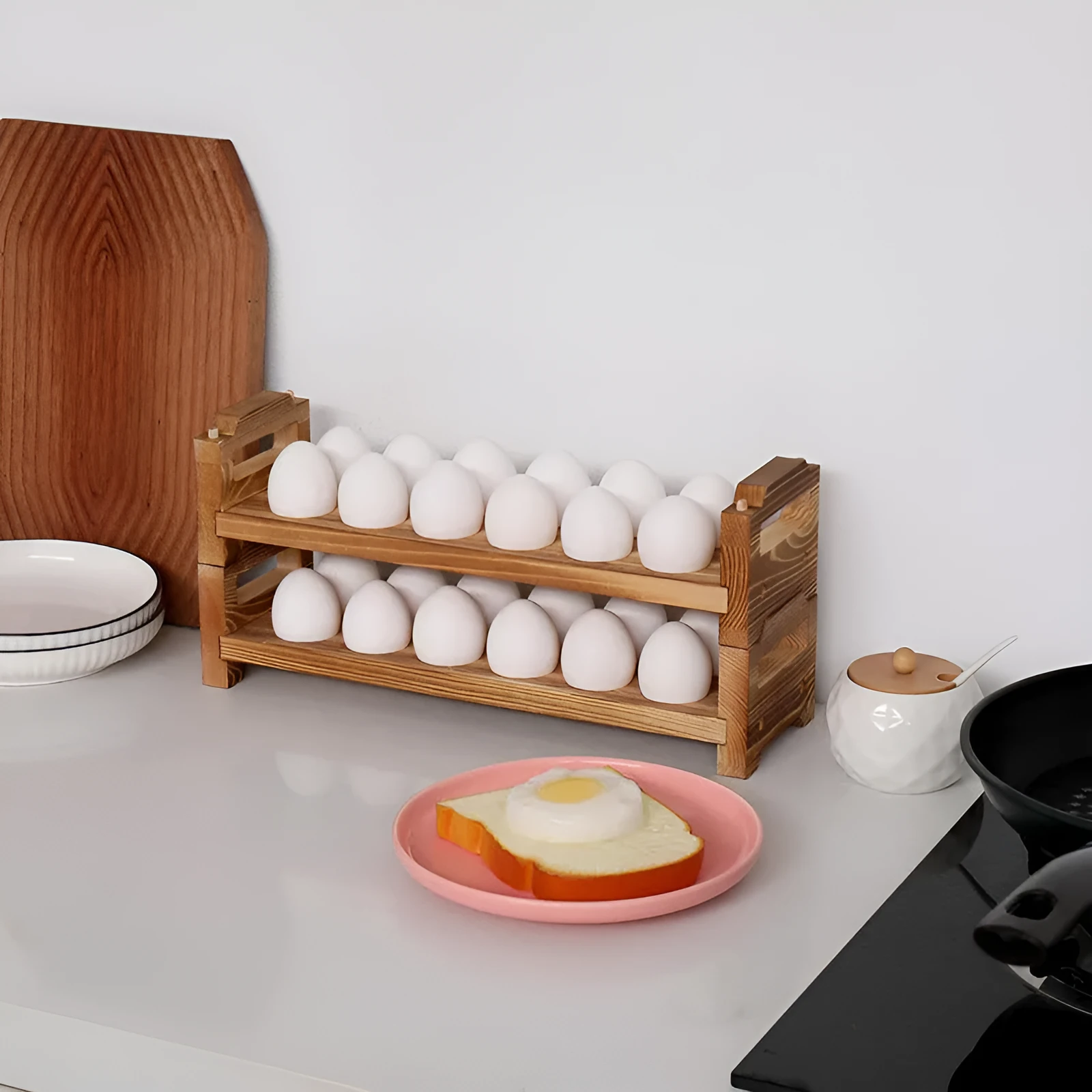 Solid wood egg storage rack in red Fire colour on a kitchen countertop
