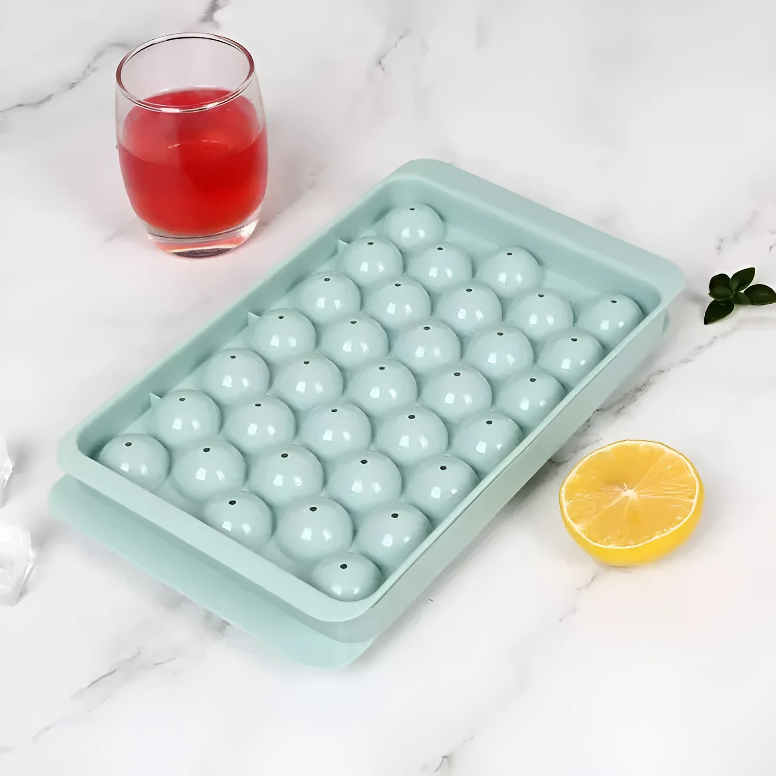 Blue silicone ice cube tray with lid showing 33 round cavities.