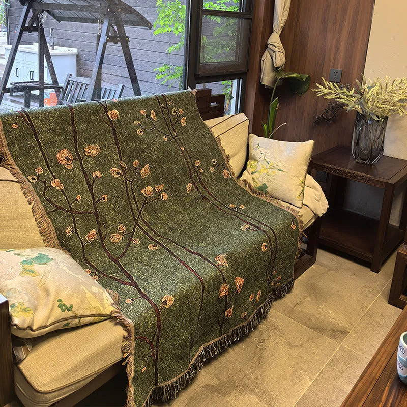 Chinese retro green plum blossom woven polyester sofa cover 130x160cm with tassels on a sofa