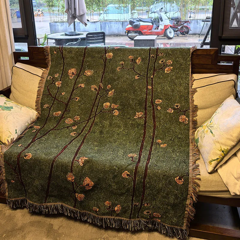 Chinese retro green plum blossom woven polyester sofa cover 130x160cm with tassels on a sofa