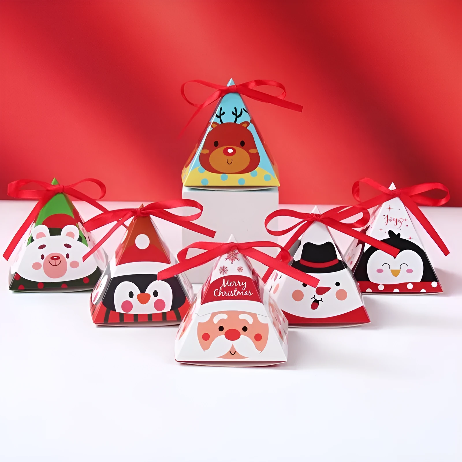 Christmas triangle candy box in paper with festive Santa and snowman print and ribbon ties
