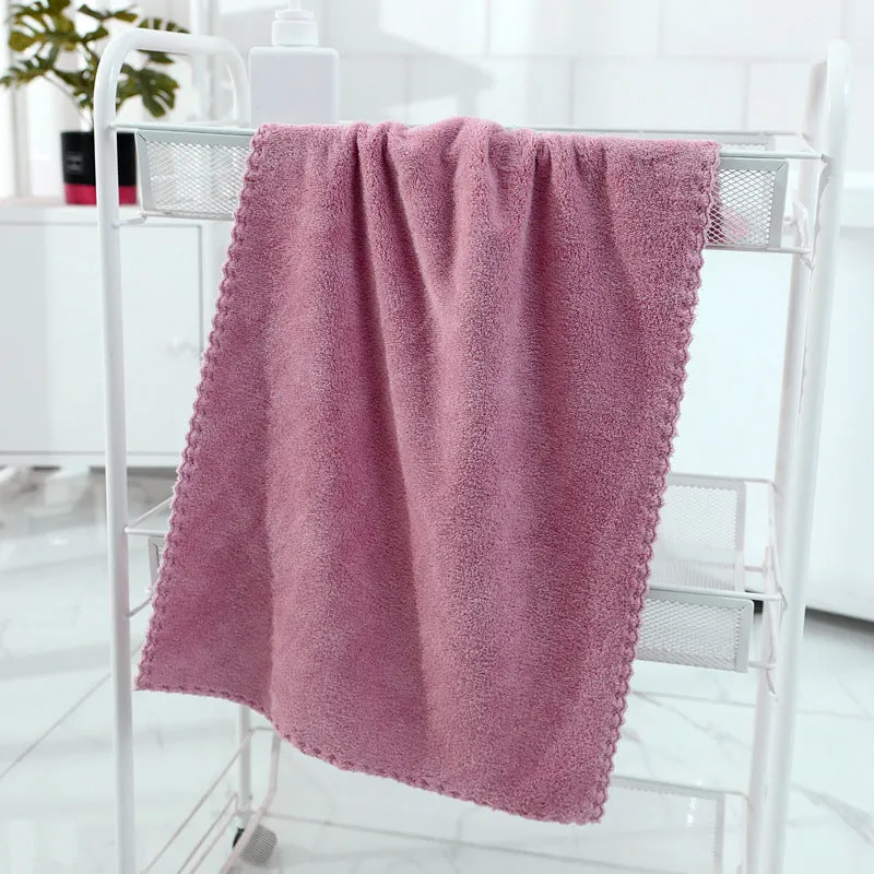 Coral fleece absorbent household towel in coral pink colour showing soft textured surface