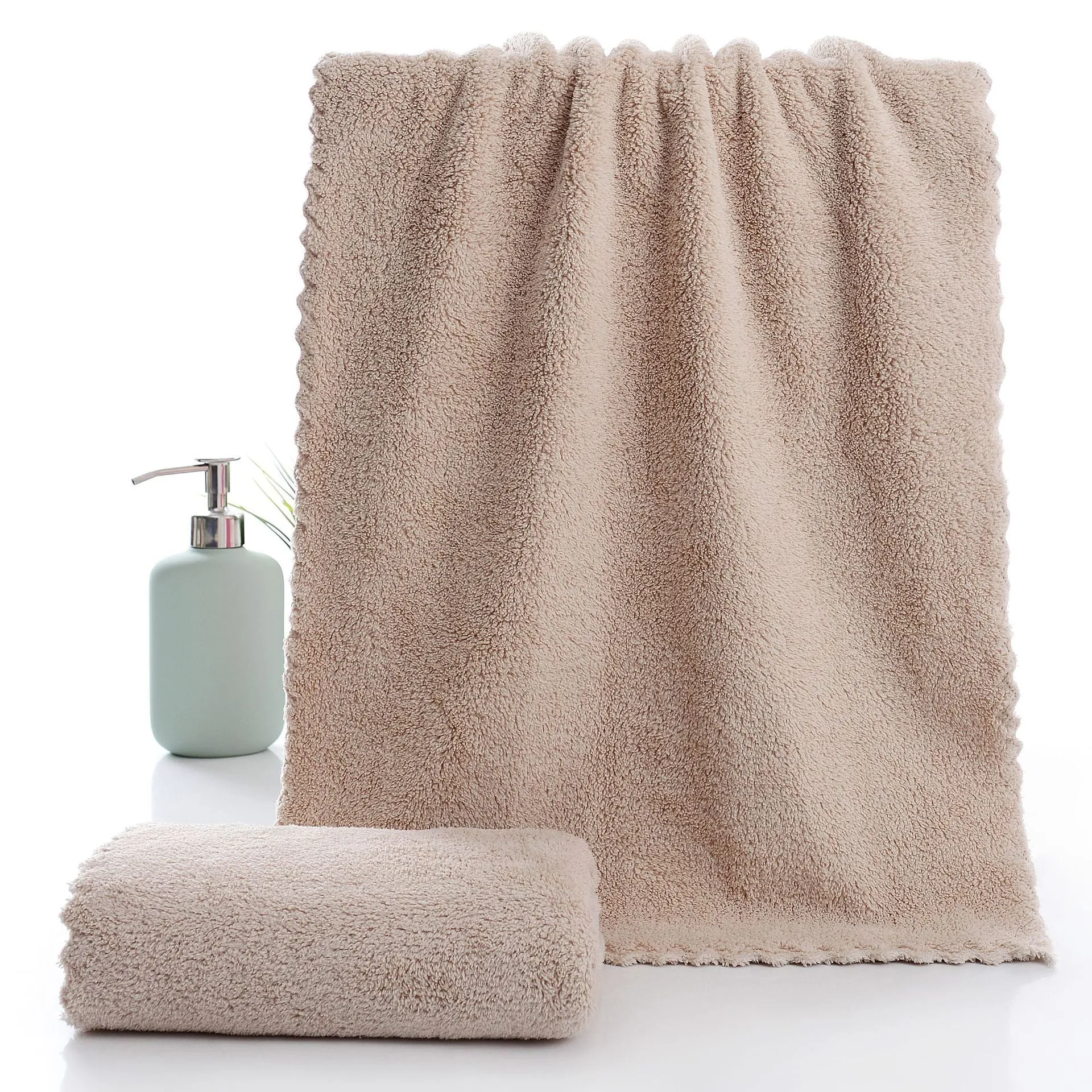 Coral fleece absorbent household towel in coral pink colour showing soft textured surface