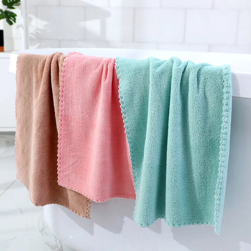 Coral fleece absorbent household towel in coral pink colour showing soft textured surface