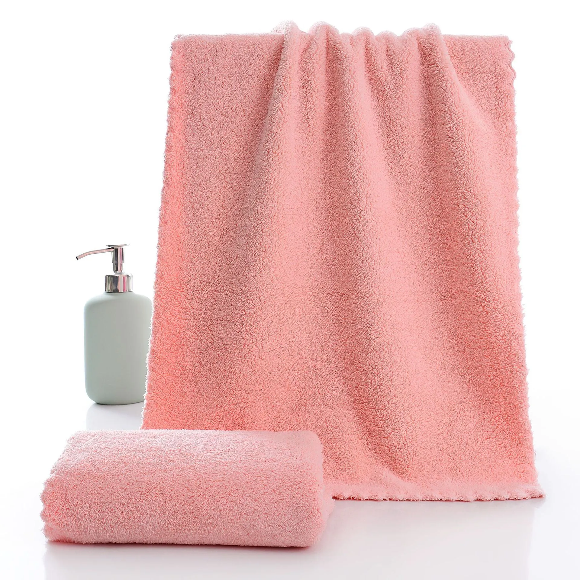 Coral fleece absorbent household towel in coral pink colour showing soft textured surface