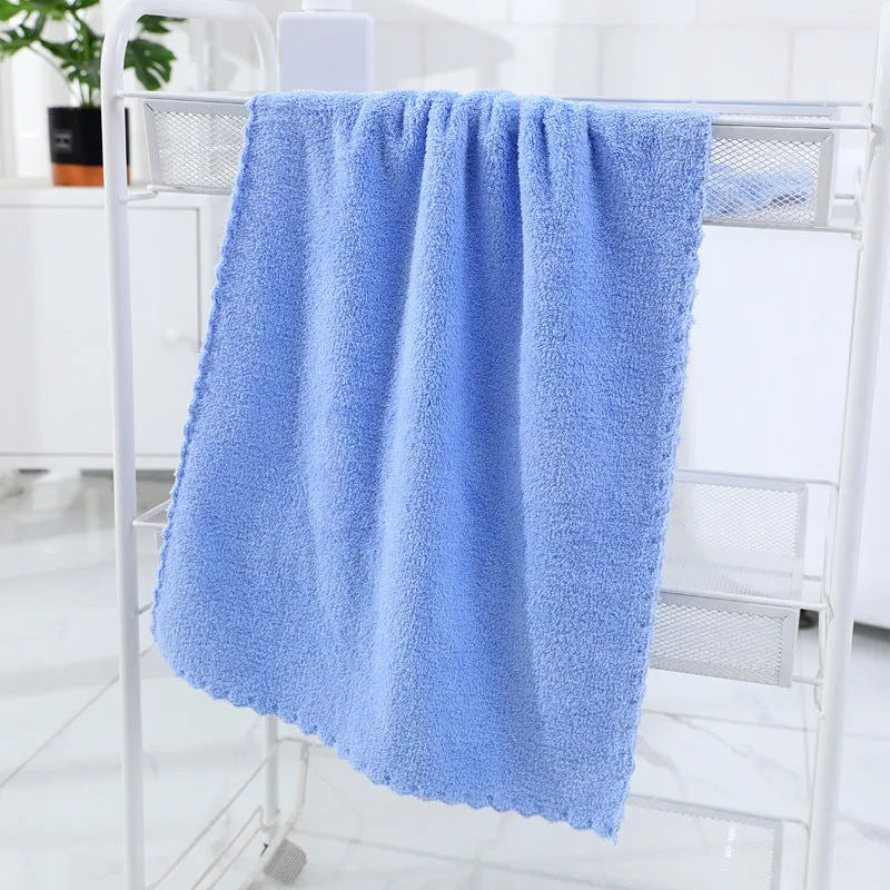 Coral fleece absorbent household towel in coral pink colour showing soft textured surface