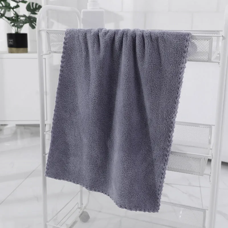 Coral fleece absorbent household towel in coral pink colour showing soft textured surface