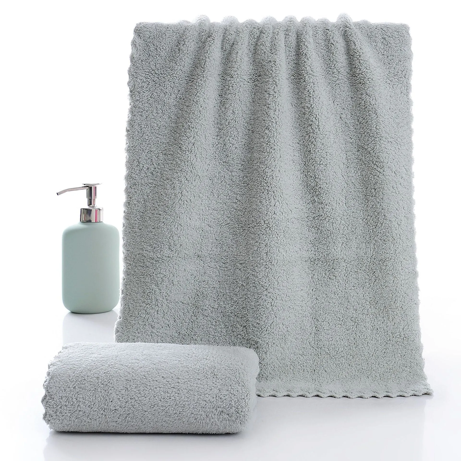 Coral fleece absorbent household towel in coral pink colour showing soft textured surface