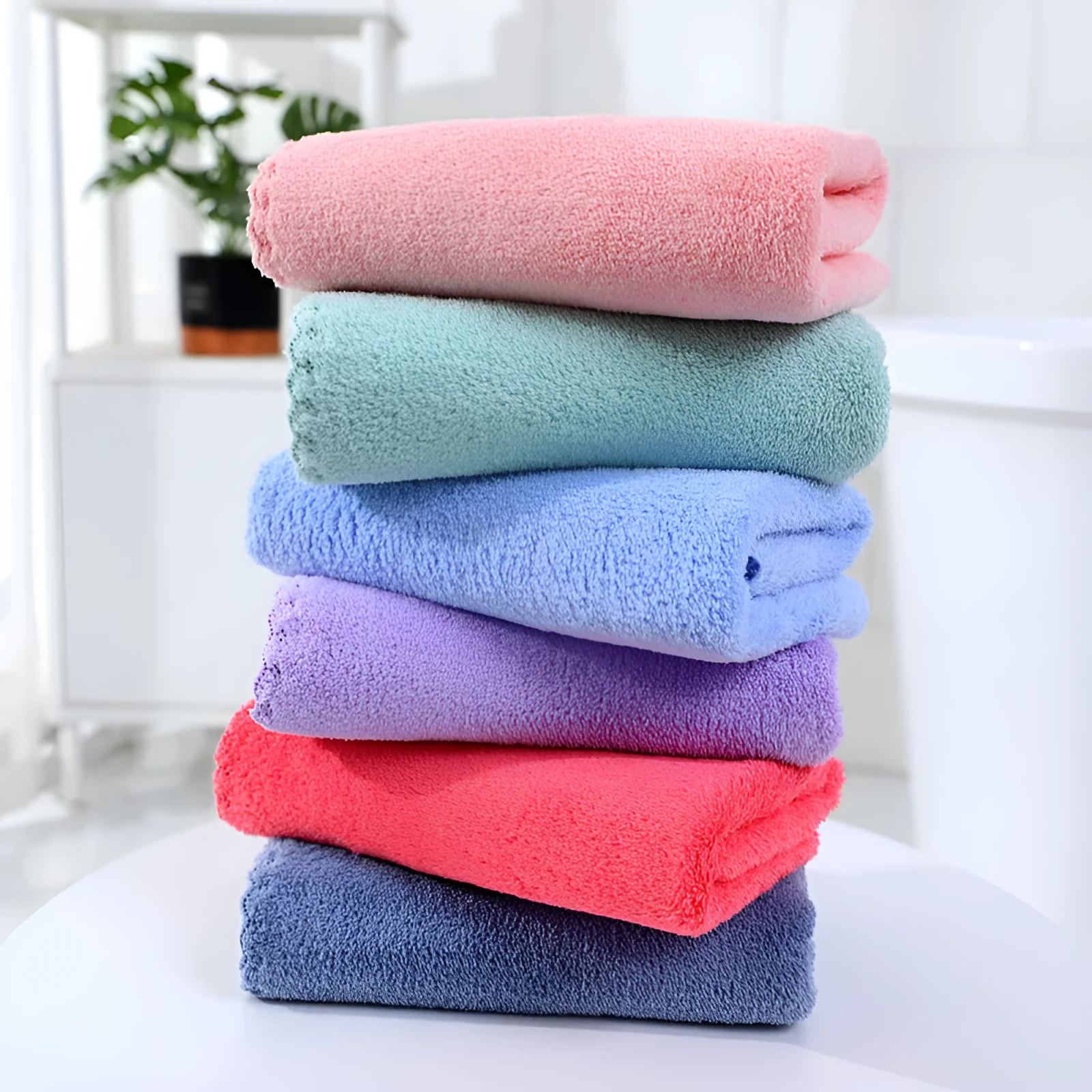 Coral fleece absorbent household towel in coral pink colour showing soft textured surface