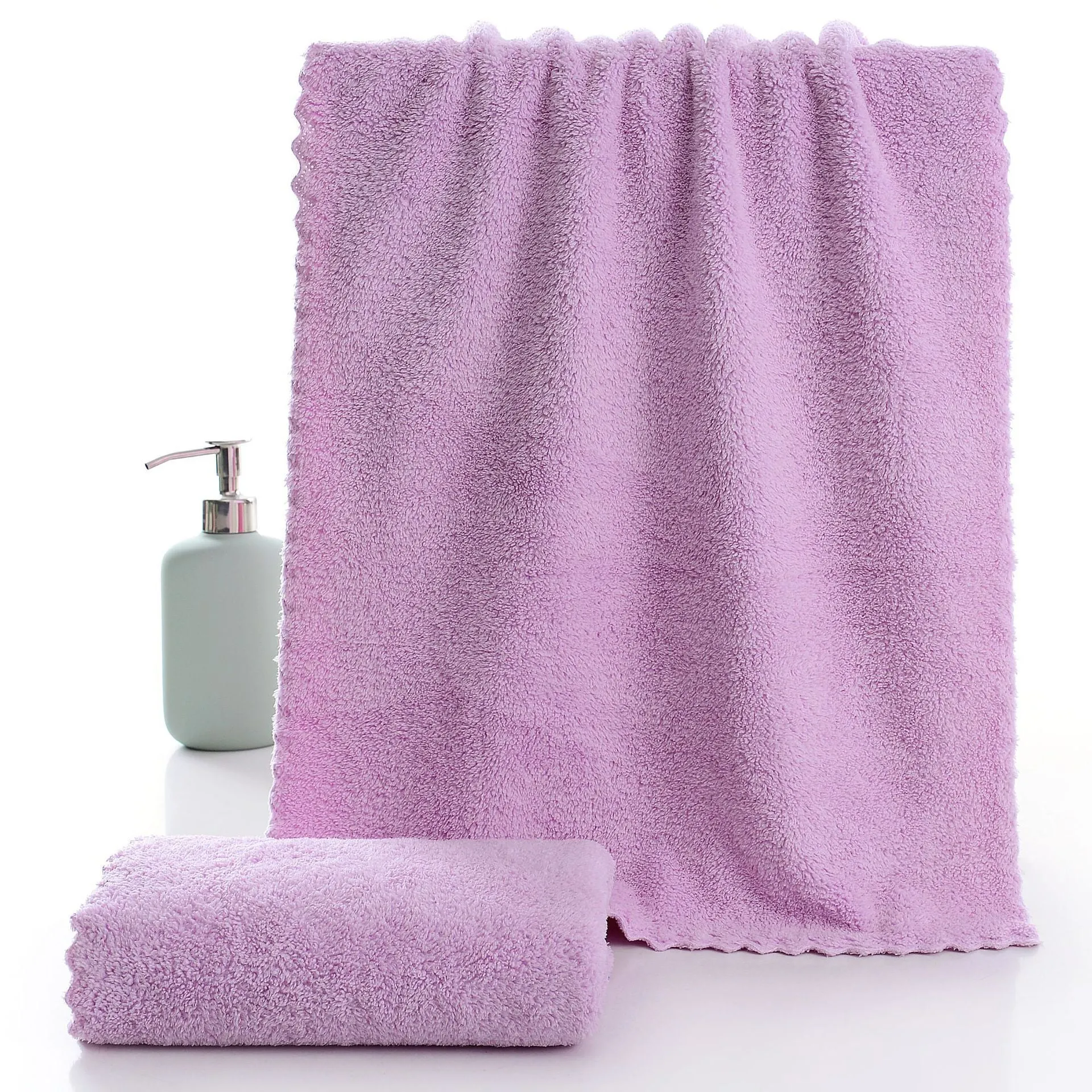 Coral fleece absorbent household towel in coral pink colour showing soft textured surface