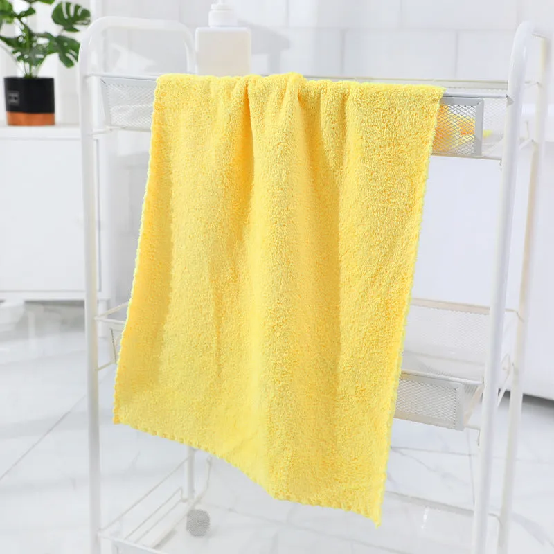 Coral fleece absorbent household towel in coral pink colour showing soft textured surface