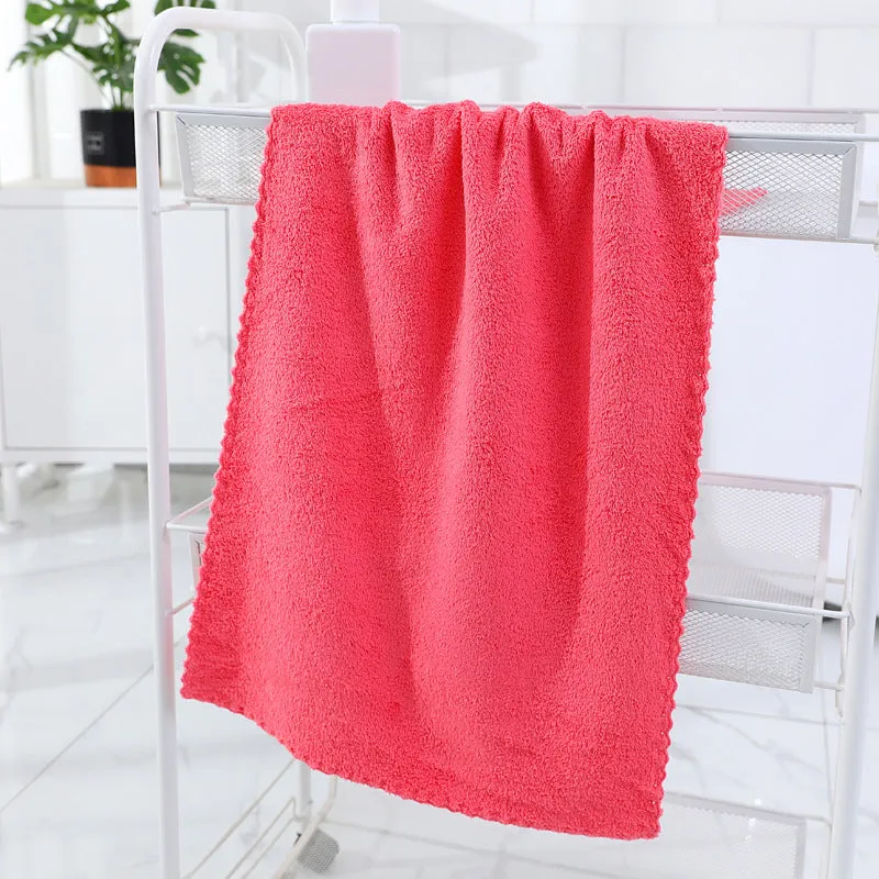 Coral fleece absorbent household towel in coral pink colour showing soft textured surface