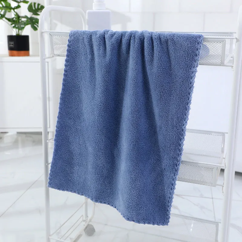 Coral fleece absorbent household towel in coral pink colour showing soft textured surface