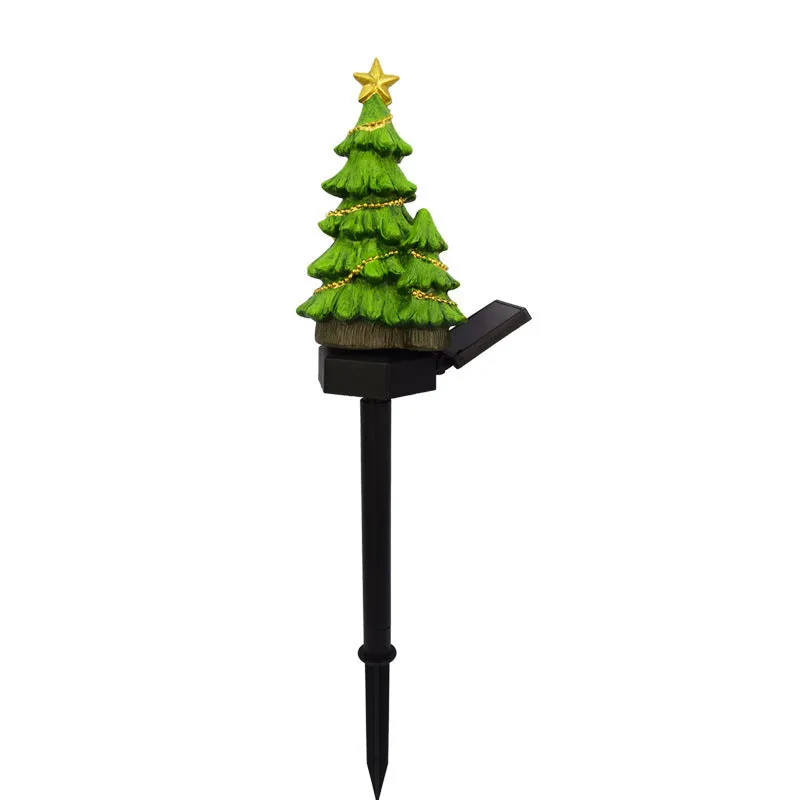 Solar Christmas tree ground plug light with warm white LED on a lawn, IP65 waterproof resin construction