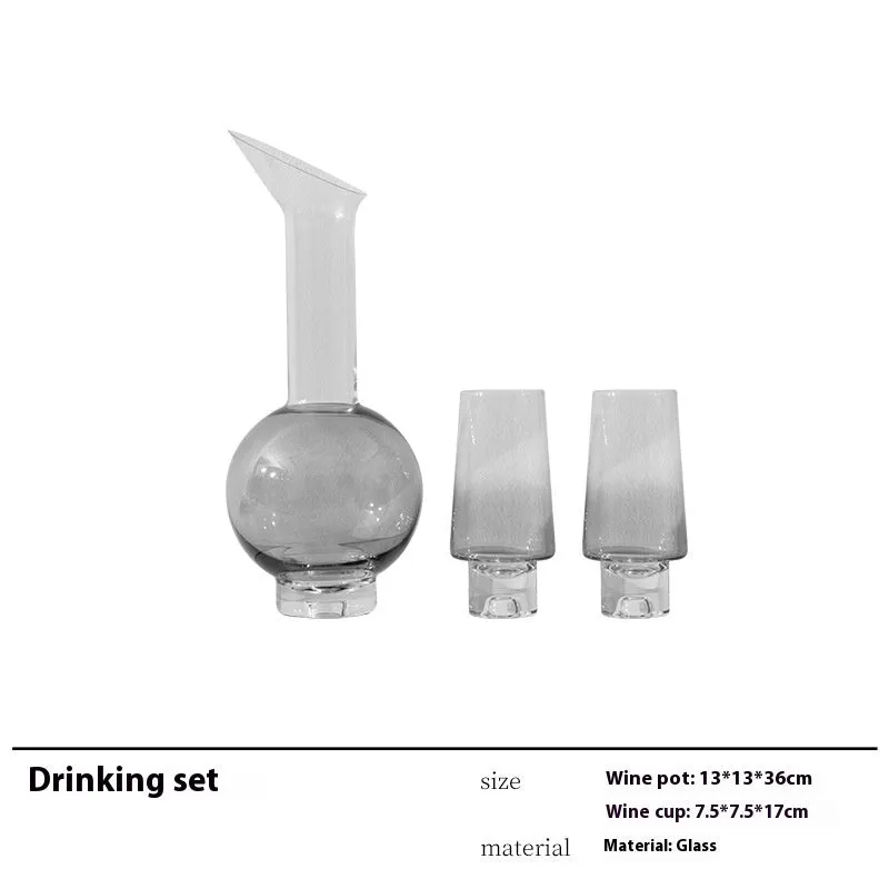 Modern wine accessories set including glassware, ice bucket, and stainless steel ornaments on a table
