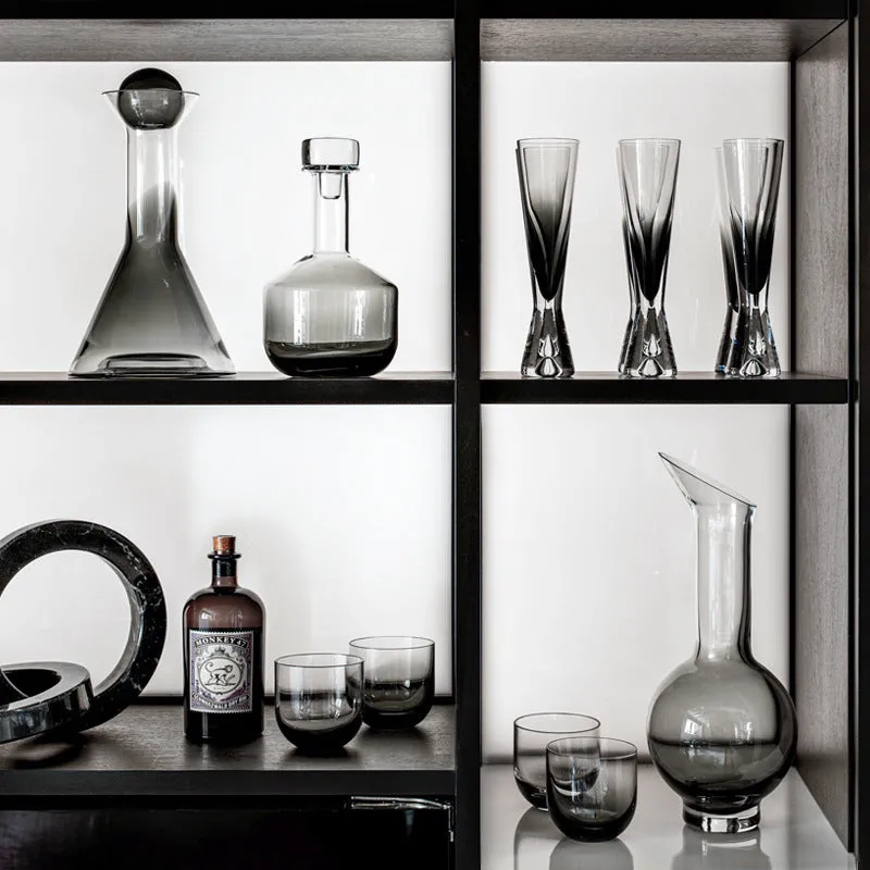 Modern wine accessories set including glassware, ice bucket, and stainless steel ornaments on a table