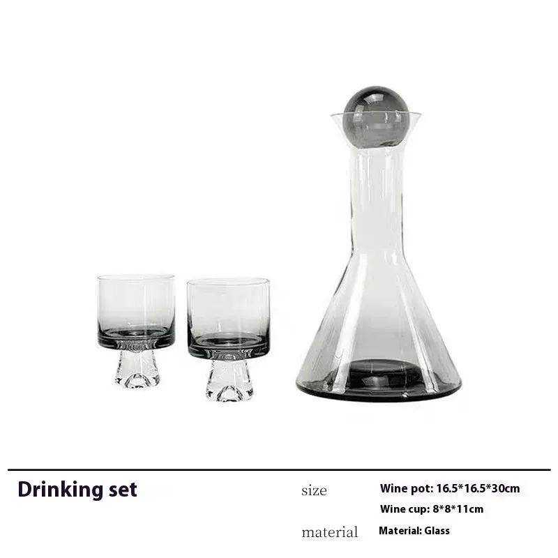 Modern wine accessories set including glassware, ice bucket, and stainless steel ornaments on a table