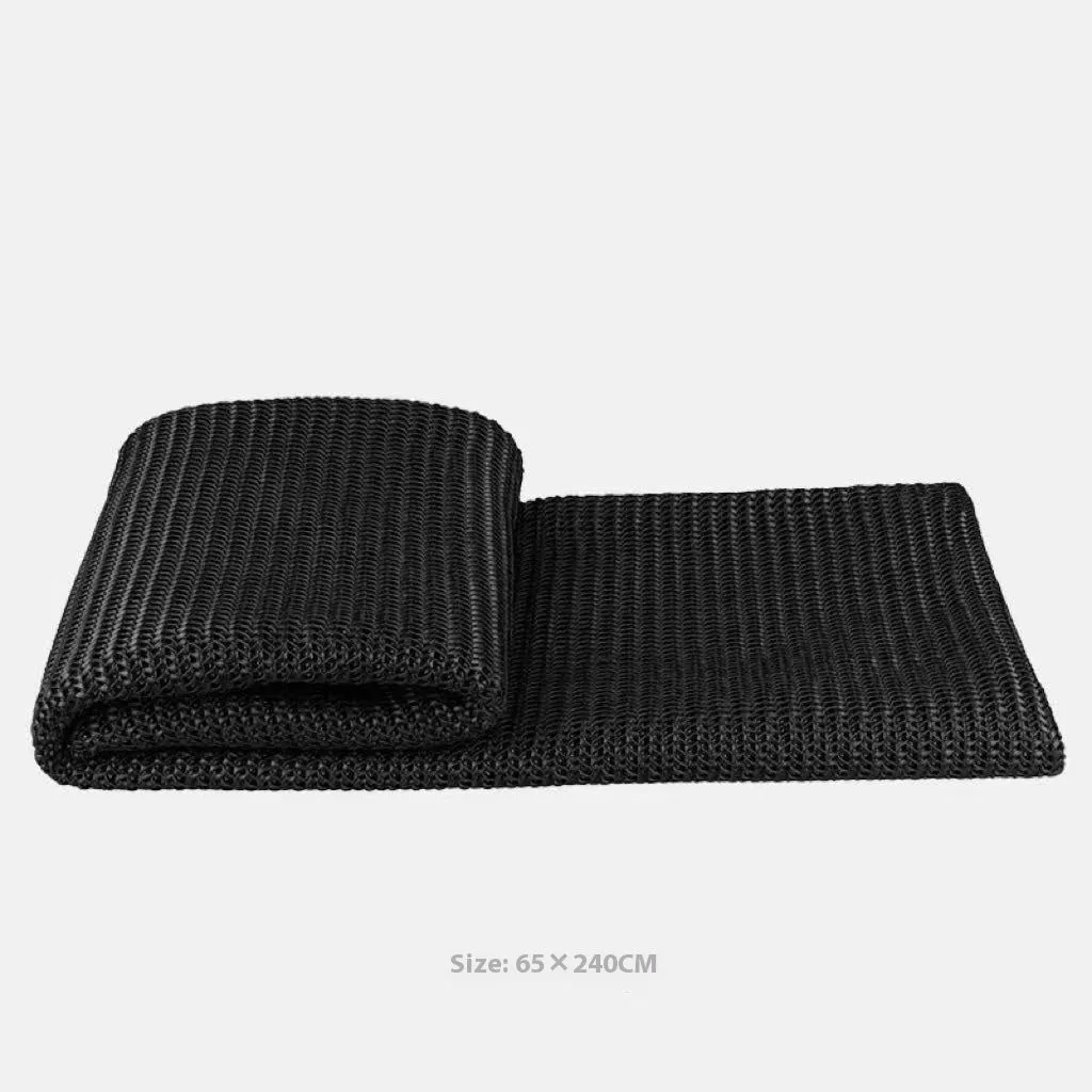 Modern grey and white plaid bed runner blanket set with round leather pillow on a bed.