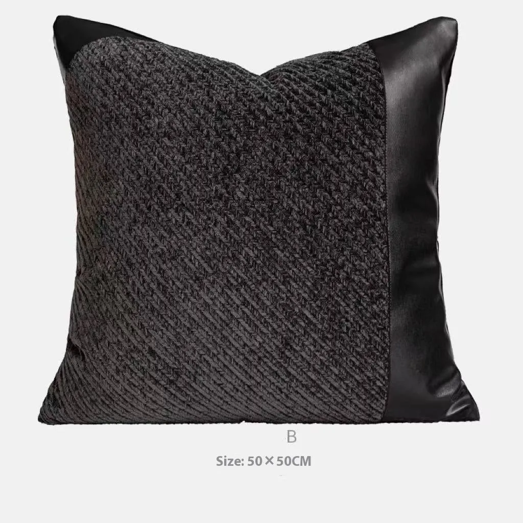 Modern grey and white plaid bed runner blanket set with round leather pillow on a bed.