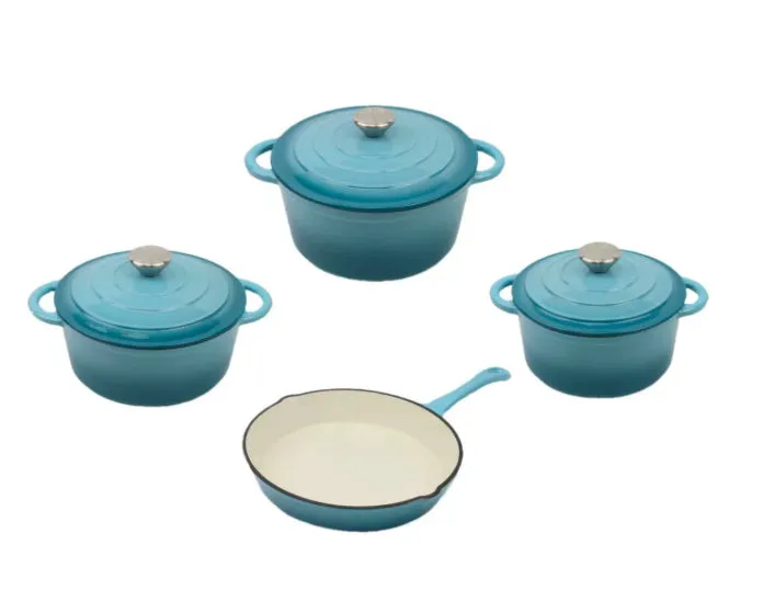 Cast iron enamel casserole set with frying pan and stew pot in light blue colour on a wooden table