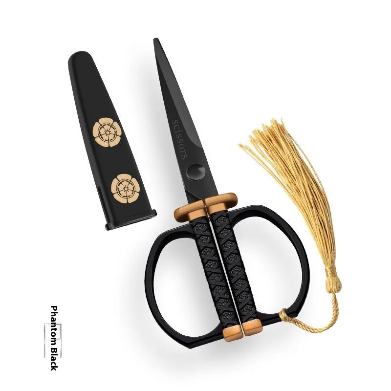 Gold, black, and silver art paper cutting scissors with straight head blades on a white background