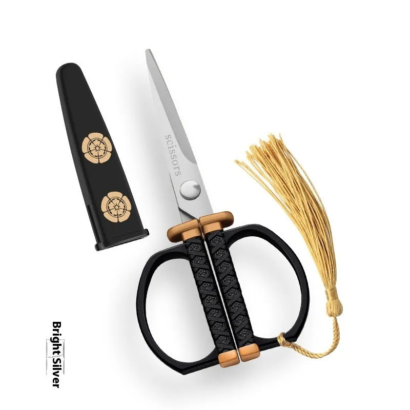 Gold, black, and silver art paper cutting scissors with straight head blades on a white background