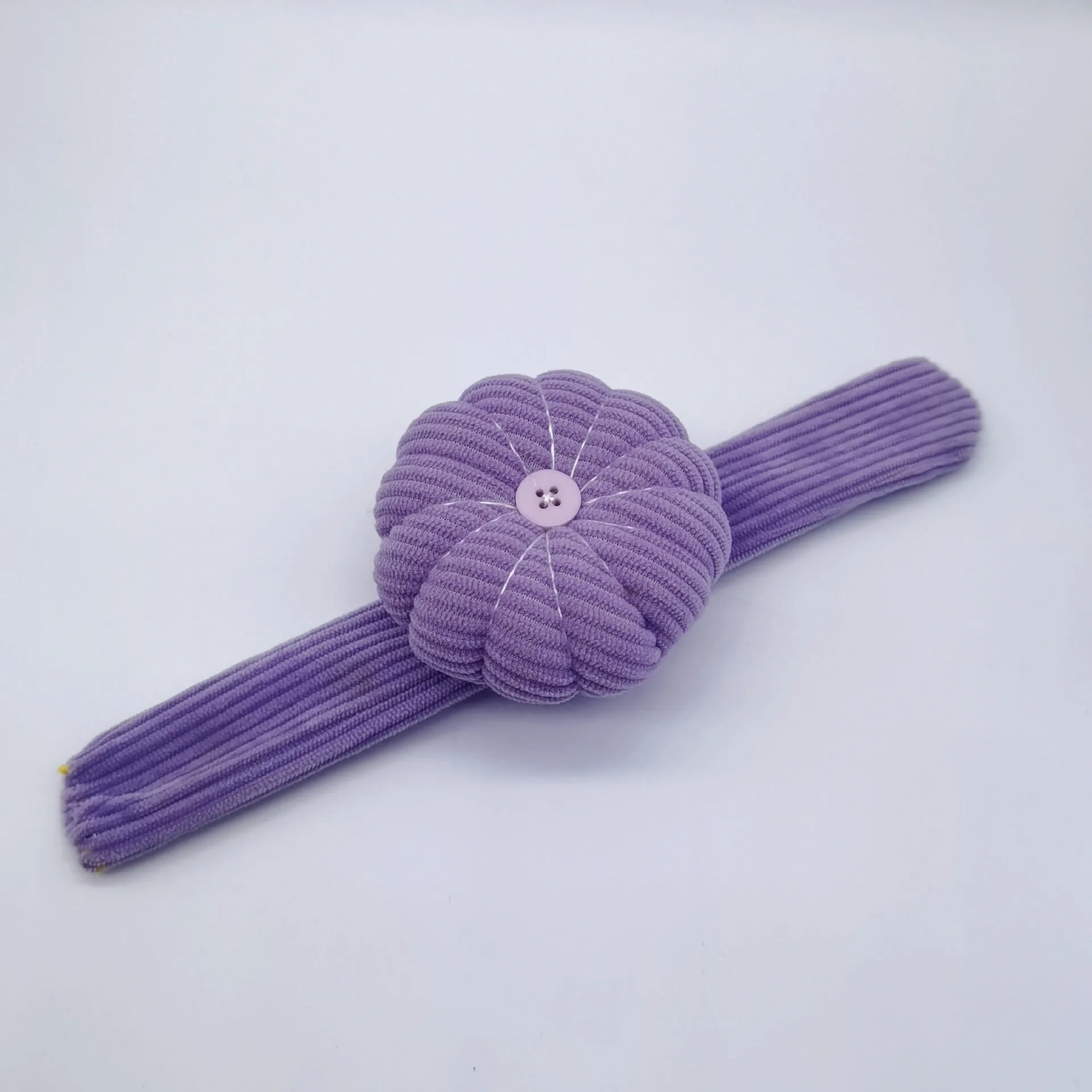 Ring pincushion sewing tool with vertical cutting slot in caramel colour showing fabric cushion and metal ring base