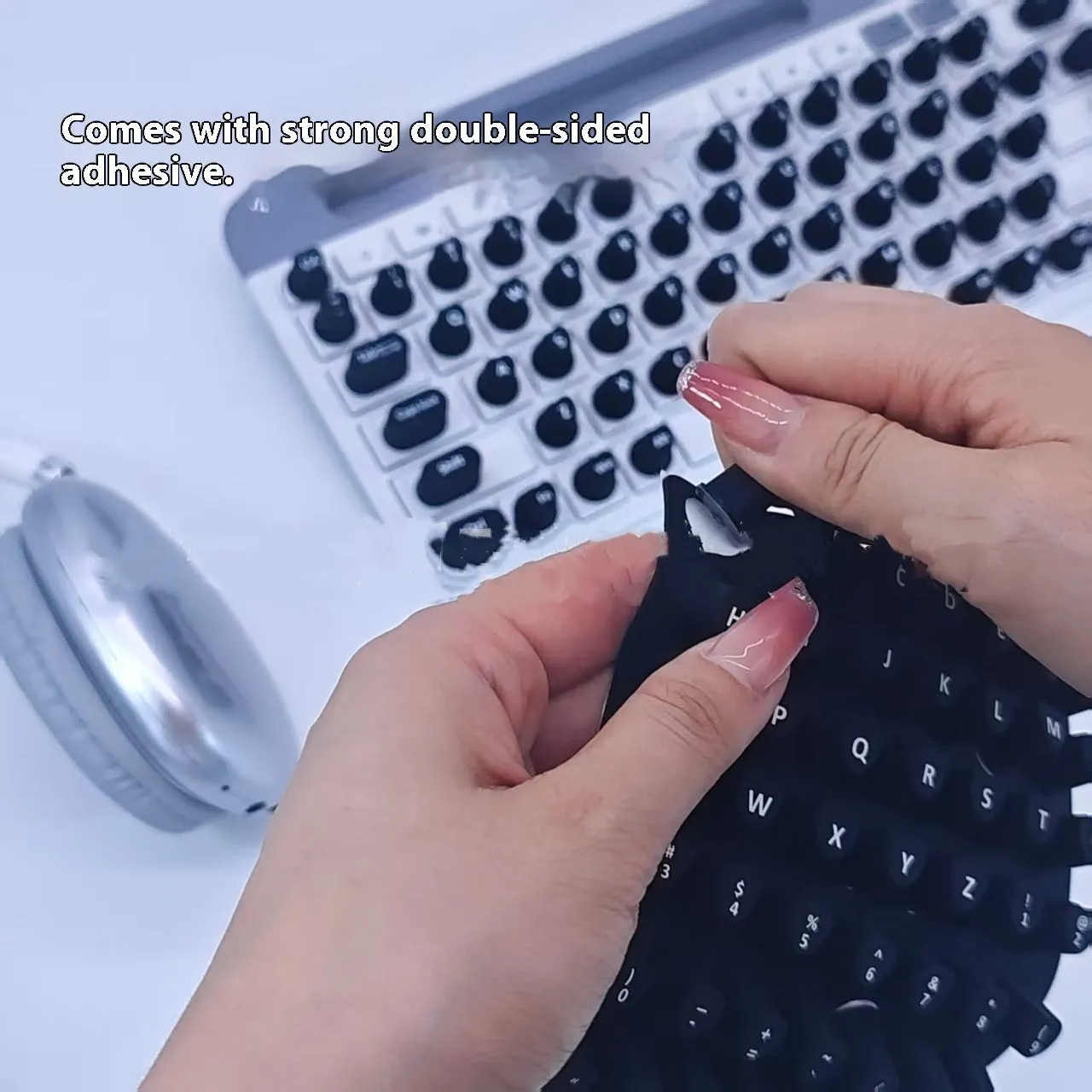 Set of 70 silicone keycap stickers in black for nail protection on a keyboard